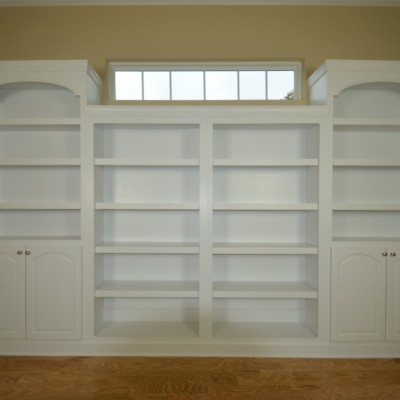 Massive custom book shelf built-in with arched details. Full frame design and a perfect fit.