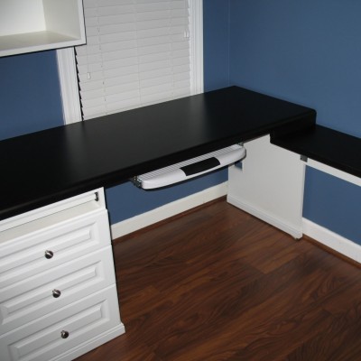 A real working shared home office for real working sales reps. Has a keyboard tray, files, and a cubby for the printer, upper cabinets and nice trim details, with a wrap-around top.