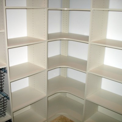 Adjustable performance reigns supreme in this pantry. Curved corner shelves and pull-out baskets round out the storage.
