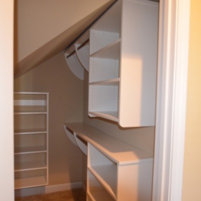 Double hang and shelves maximize a modest space under the stairs.