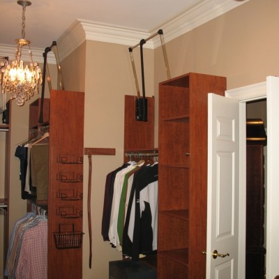 In this closet, tall ceilings and tall panels allow for triple hanging. Pull down (pneumatic) lifts make it convenient.