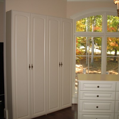 Double tall cabinets provide the "pedestals" for almost 100 pairs of shoes.