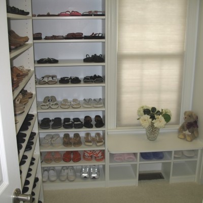 Shoe closet with adjustable spaces for flats, heels, and boots, And a seat too.