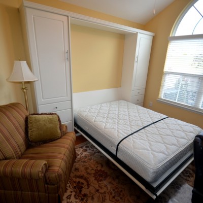 When guests arrive, this home office takes a break as our wall bed "lays down on the job."