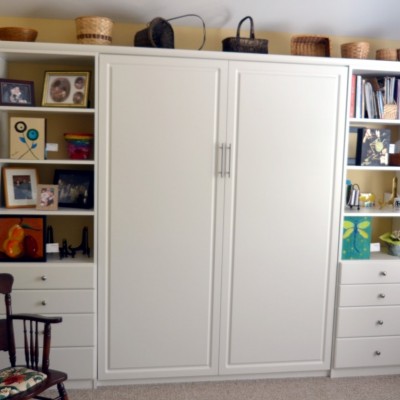 "Artist in residence." One of many repeat clients, this professional artist was creating in a laundry room when she "downsized." We out-placed the rarely used guest suite and up-fit a beautiful wall bed and staggered side cabinets. The opposite wall carries an art shelf for work in progress.